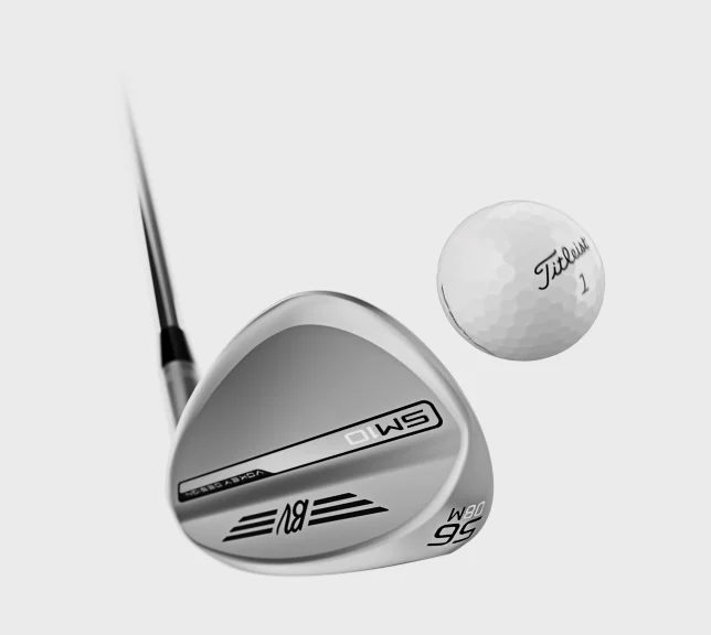 An SM10 Vokey Design iron clubhead striking a Titleist golf ball.