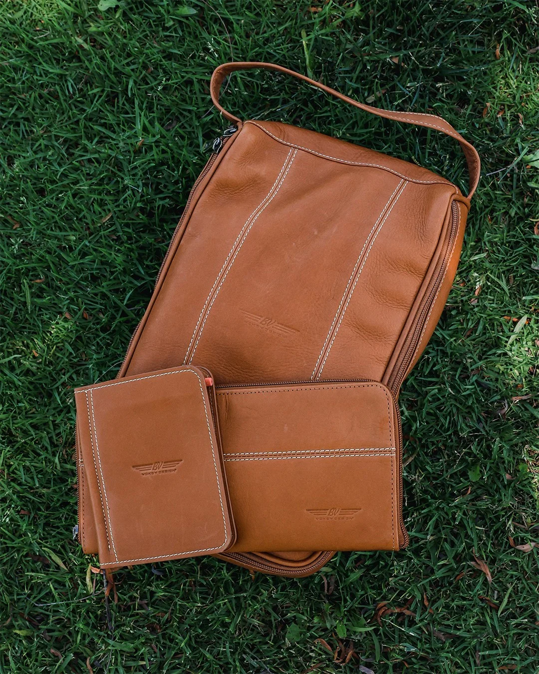 Vokey Premium logo-embossed brown leather accessories: shoe bag, glove keeper, and scorecard holder.
